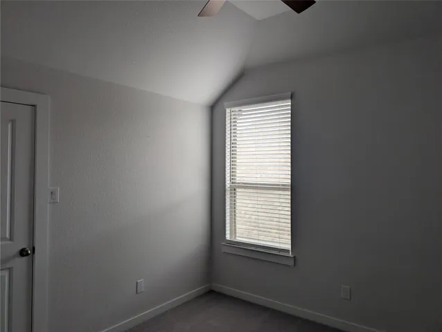 a view of an empty room and a window