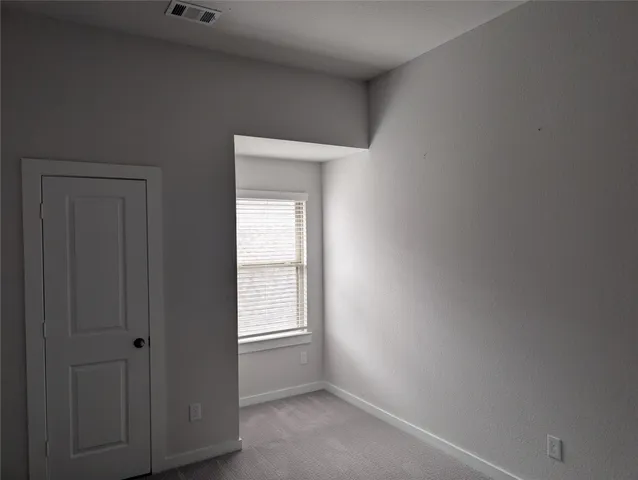 a view of an empty room with closet