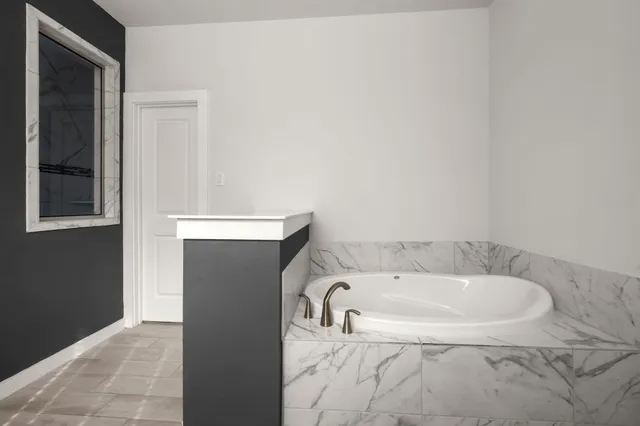 a bathroom with a bathtub and a sink