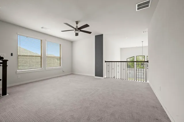 a view of a livingroom with a ceiling fan and window