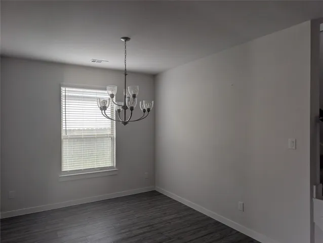 a view of a room with window wooden floor and chandelier