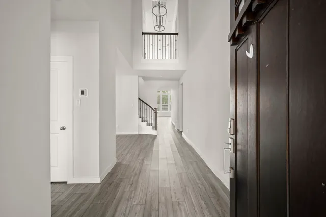 a view of a hallway with wooden floor