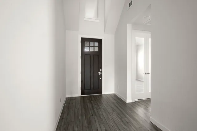 a view of a hallway with wooden floor