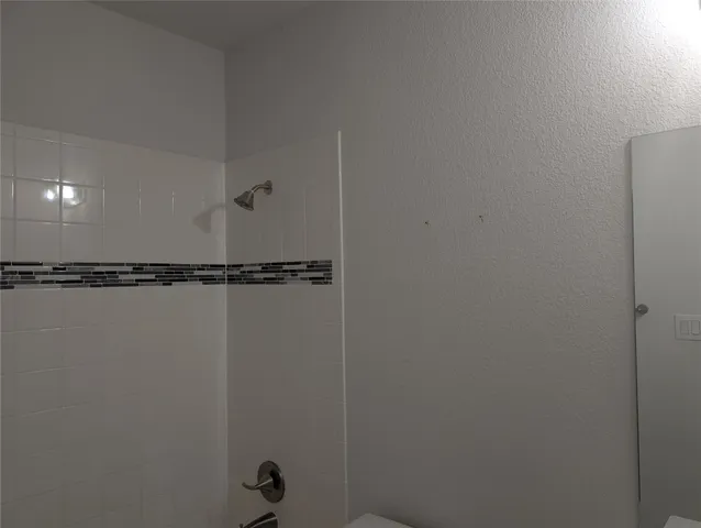 a kitchen with stainless steel appliances granite countertop a stove a refrigerator a white table and chairs