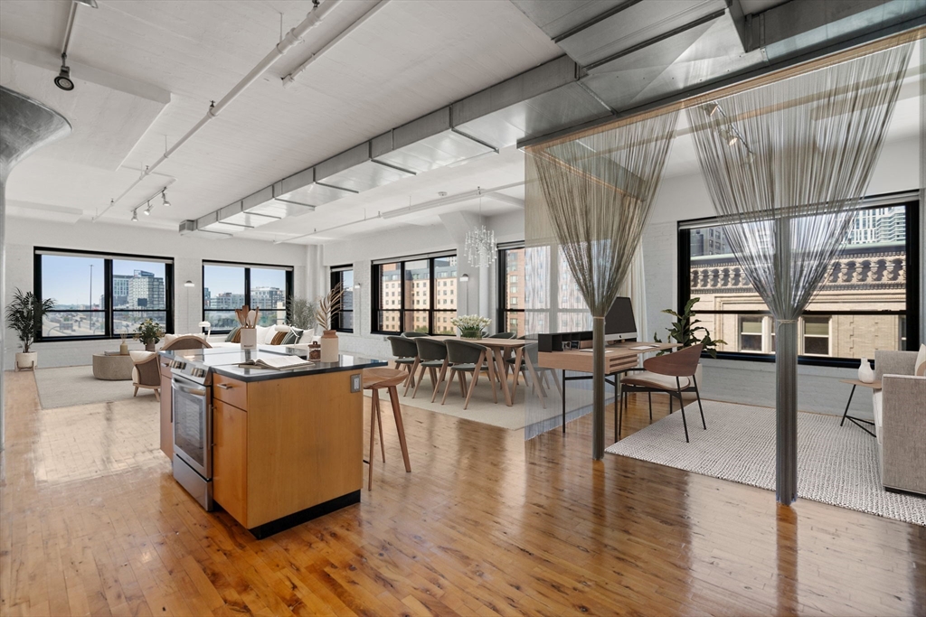 a living room with fireplace furniture and a wooden floor