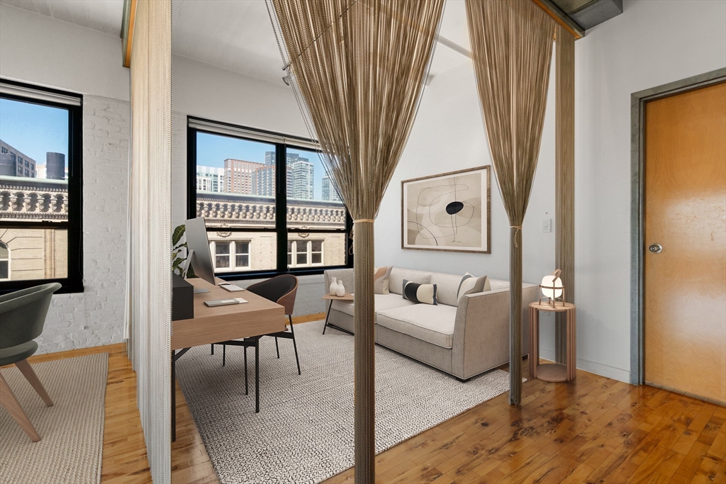 210 Lincoln Street, Unit 601 Boston, MA 02111 - Photo 11 of 29 a living room with furniture and a painting on the wall