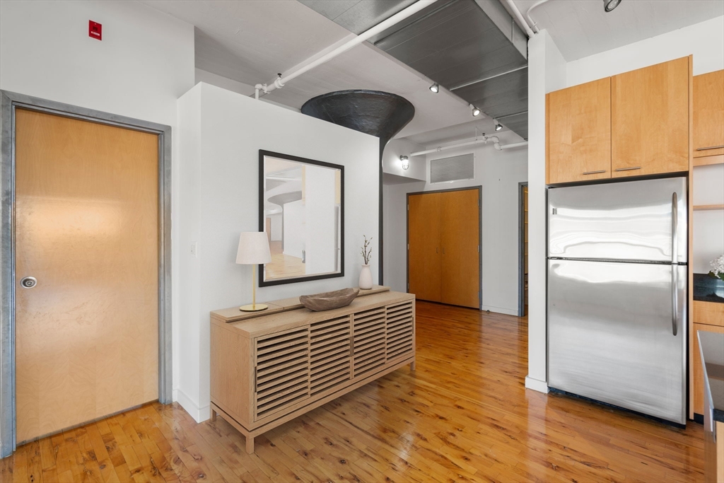 210 Lincoln Street, Unit 601 Boston, MA 02111 - Photo 16 of 29 a view of hallway with a large window and wooden floor