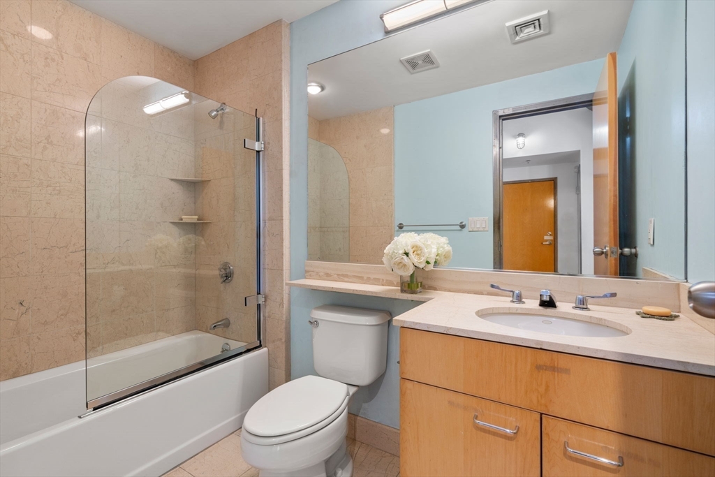 210 Lincoln Street, Unit 601 Boston, MA 02111 - Photo 18 of 29 a bathroom with a sink a toilet and shower