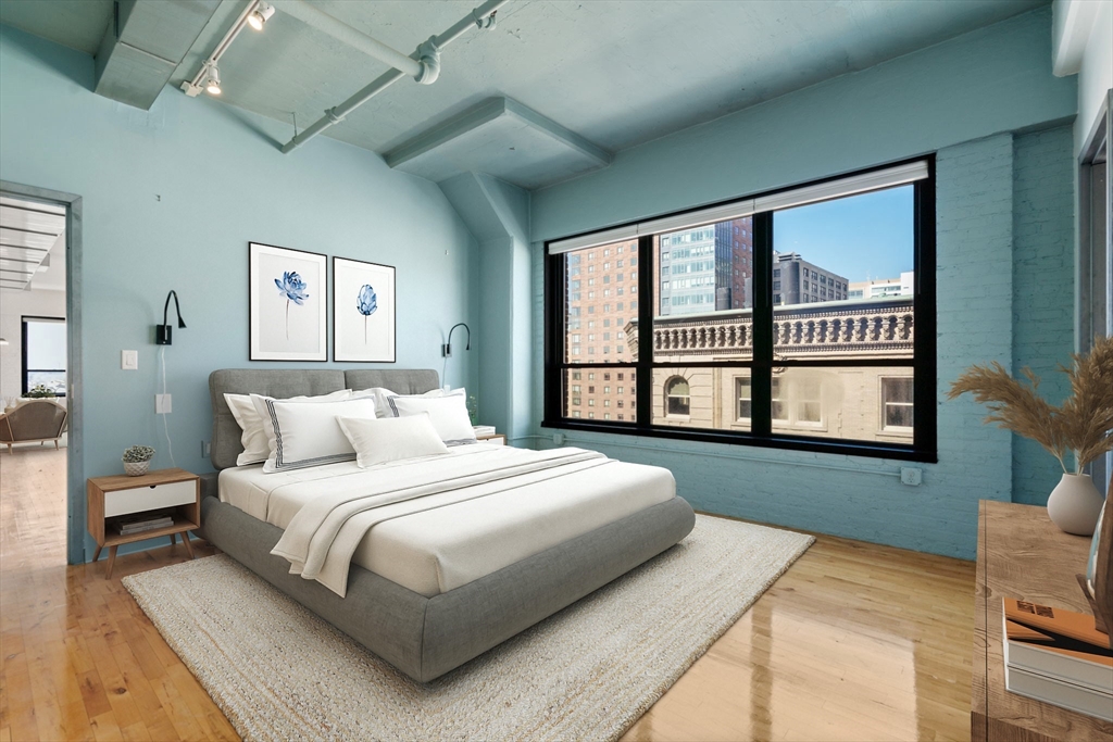 210 Lincoln Street, Unit 601 Boston, MA 02111 - Photo 20 of 29 a bedroom with a large bed and a large window