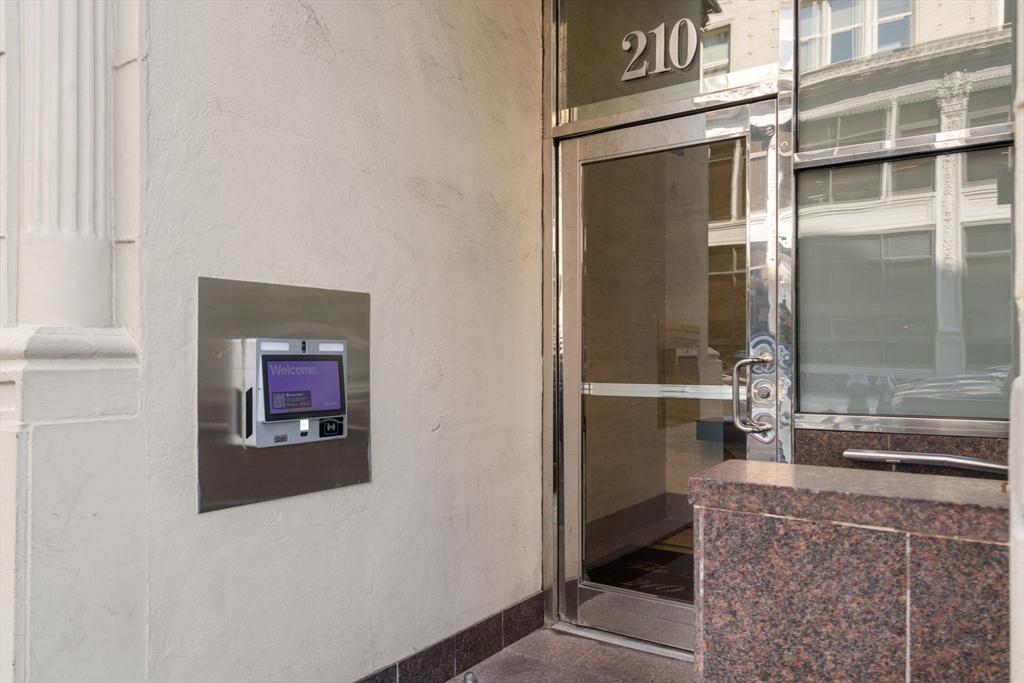 210 Lincoln Street, Unit 601 Boston, MA 02111 - Photo 28 of 29 a hallway with a glass door and shower