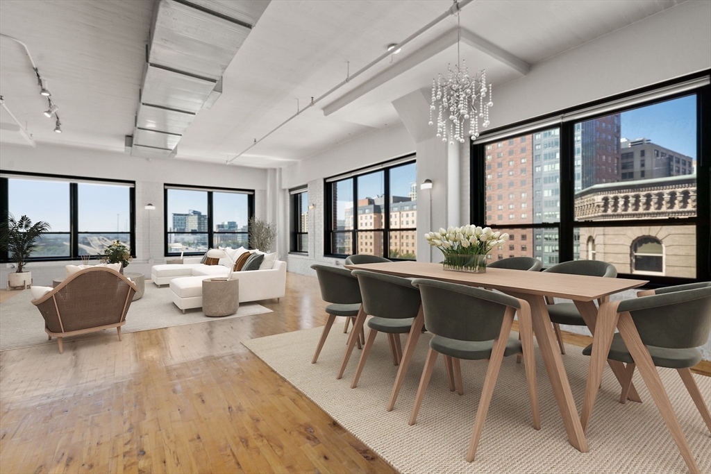 210 Lincoln Street, Unit 601 Boston, MA 02111 - Photo 3 of 29 a living room with furniture a chandelier and a large window