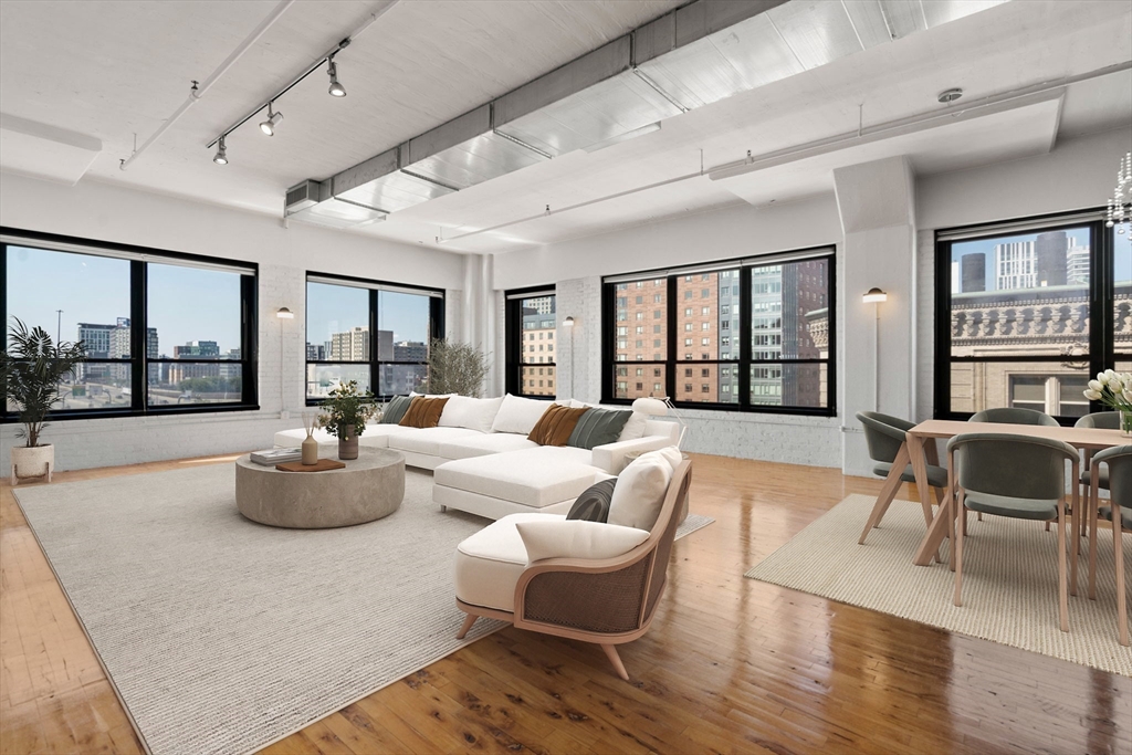 210 Lincoln Street, Unit 601 Boston, MA 02111 - Photo 4 of 29 a living room with furniture and a large window