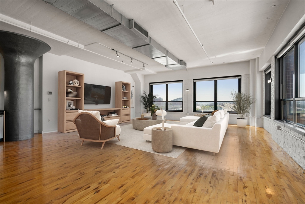 210 Lincoln Street, Unit 601 Boston, MA 02111 - Photo 5 of 29 a living room with furniture flat screen tv and large window