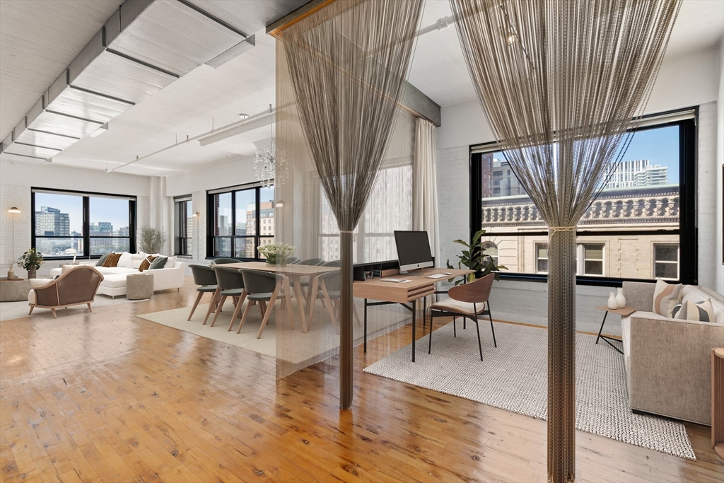 210 Lincoln Street, Unit 601 Boston, MA 02111 - Photo 8 of 29 a living room with furniture a table and large windows
