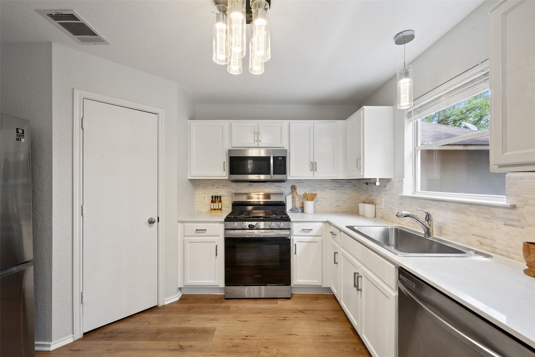 4529 Best Way Austin, TX 78725 - Photo 1 of 34 Beautifully updated kitchen with quartz countertops and a full sized pantry