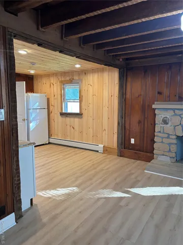 a view of a room with wooden floor and staircase