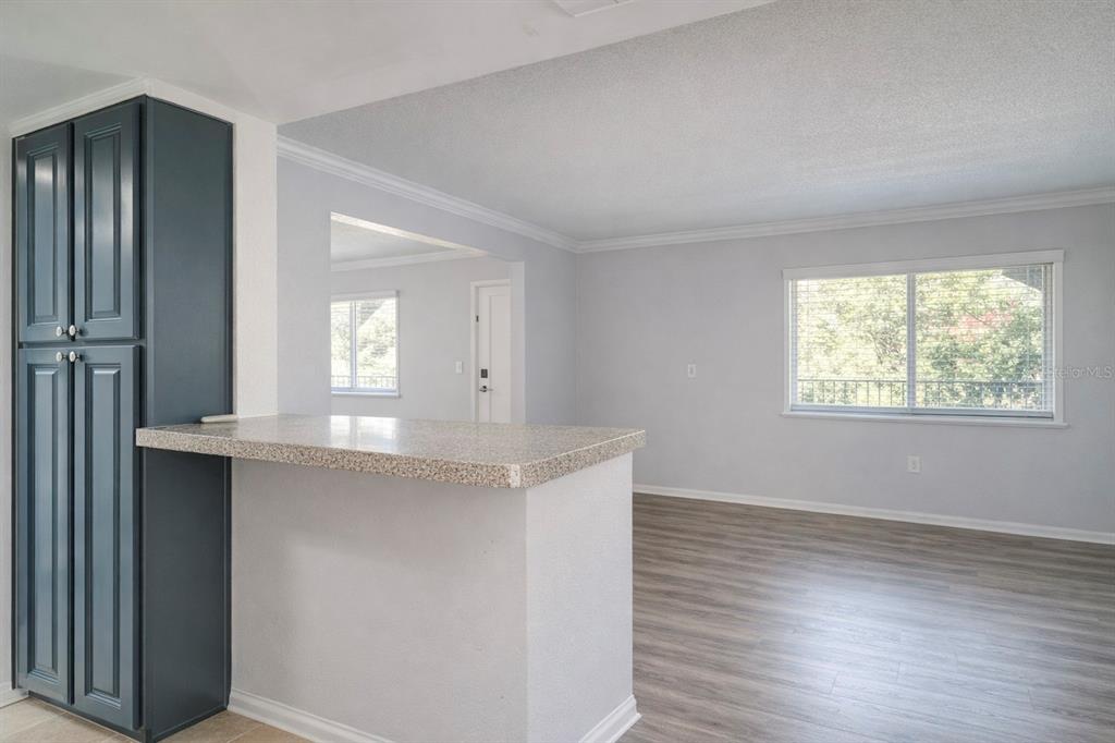 129 Blue Pointe Way, Unit 340 Altamonte Springs, FL 32701 - Photo 7 of 25 an empty room with wooden floor cabinet and windows