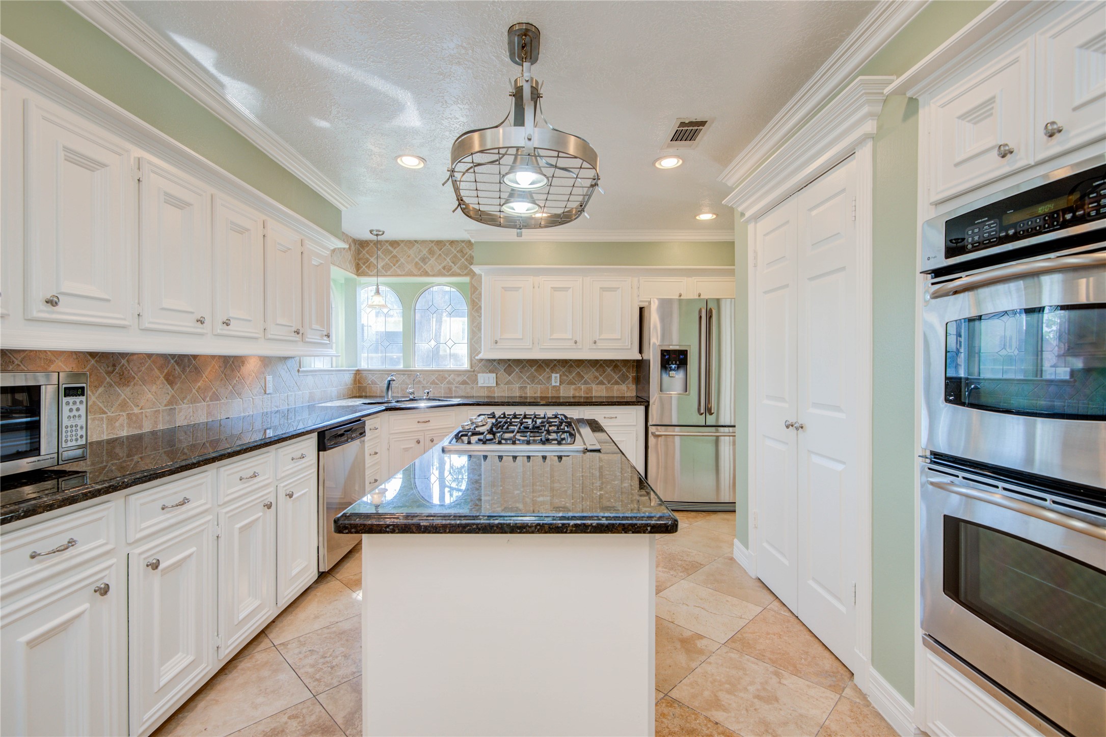 8906 Herts Road Spring, TX 77379 - Photo 11 of 43 a kitchen with stainless steel appliances granite countertop a stove and cabinets