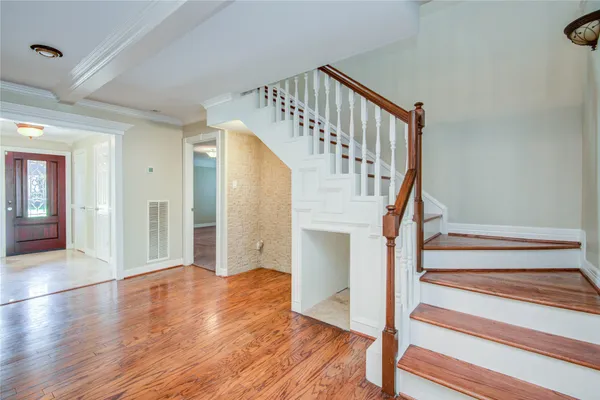 a view of entryway and hall with wooden floor