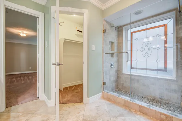 a view of a bathroom with a glass door shower