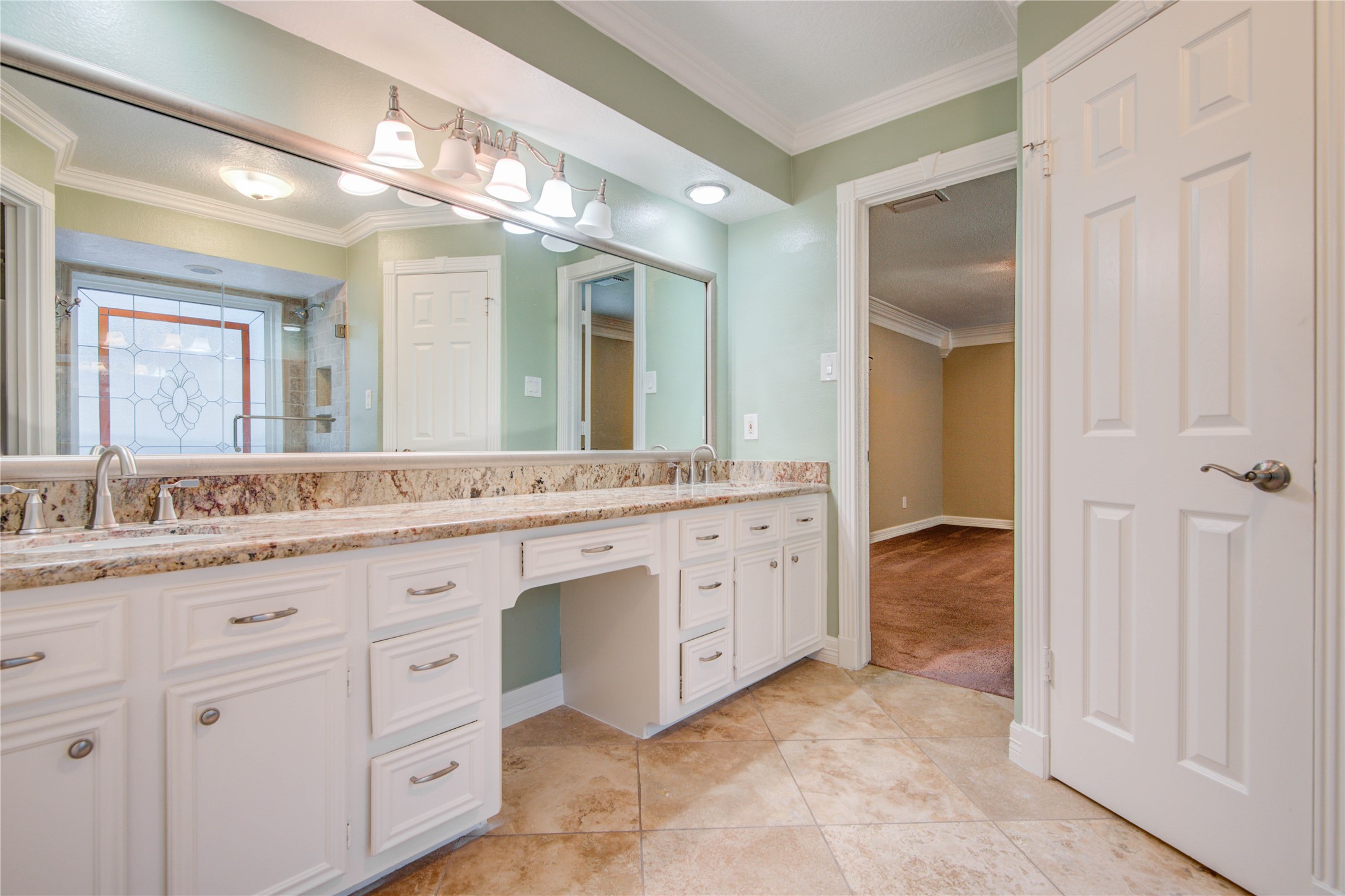 8906 Herts Road Spring, TX 77379 - Photo 27 of 43 a spacious bathroom with a granite countertop sink a mirror and a