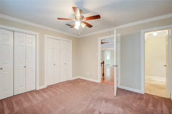 a view of a livingroom with a ceiling fan & entryway
