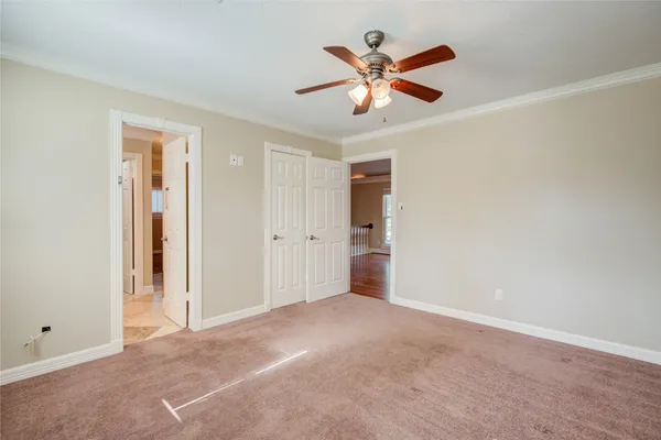 a view of a big room with closet area and ceiling fan