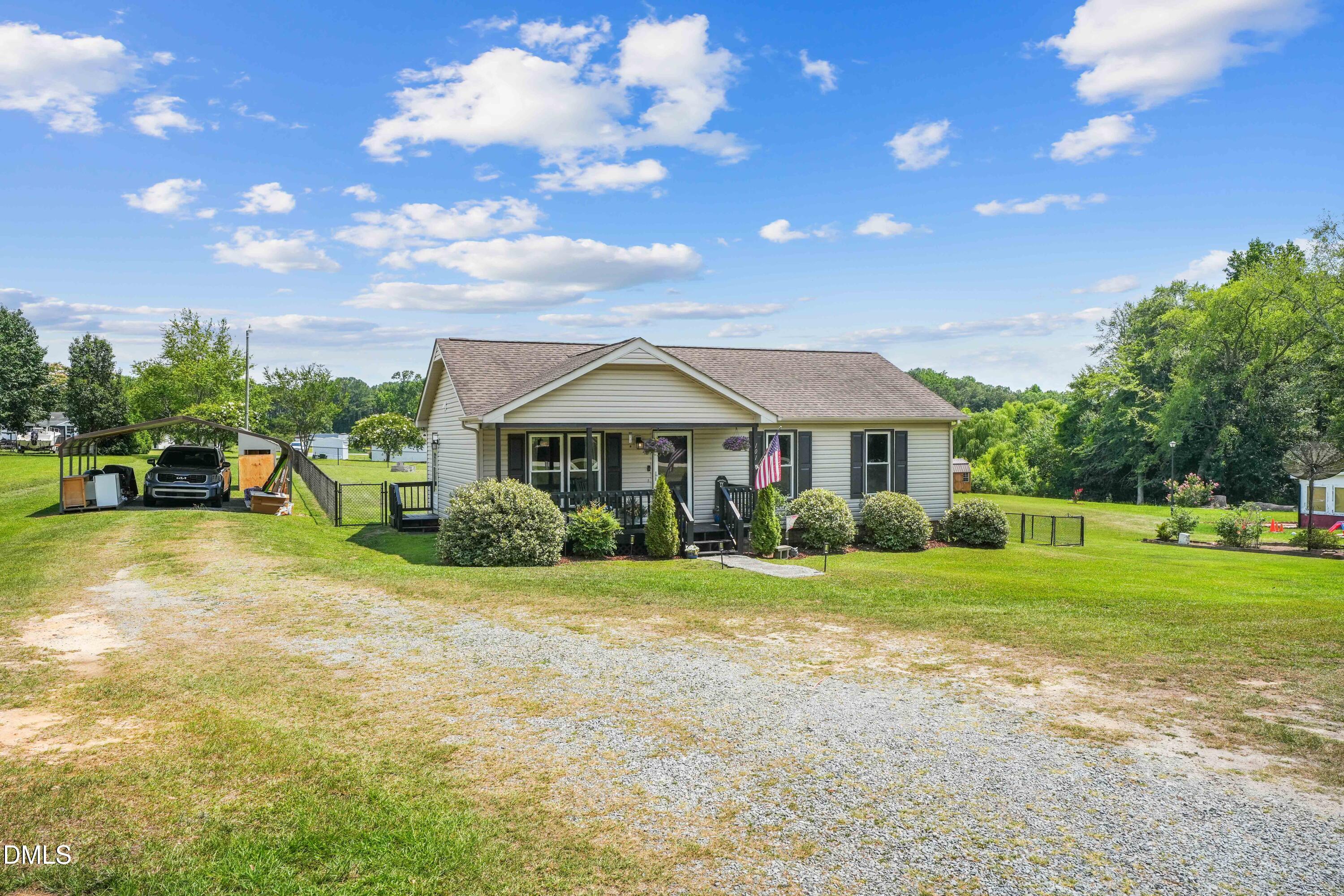 101 Stephenson Road Benson, NC 27504 - Photo 3 of 29 a front view of a house with a yard and garage