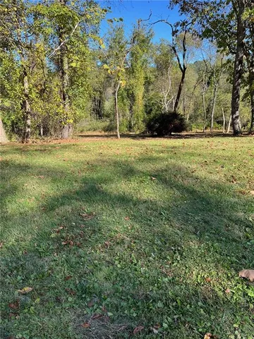 a view of outdoor space with trees all around