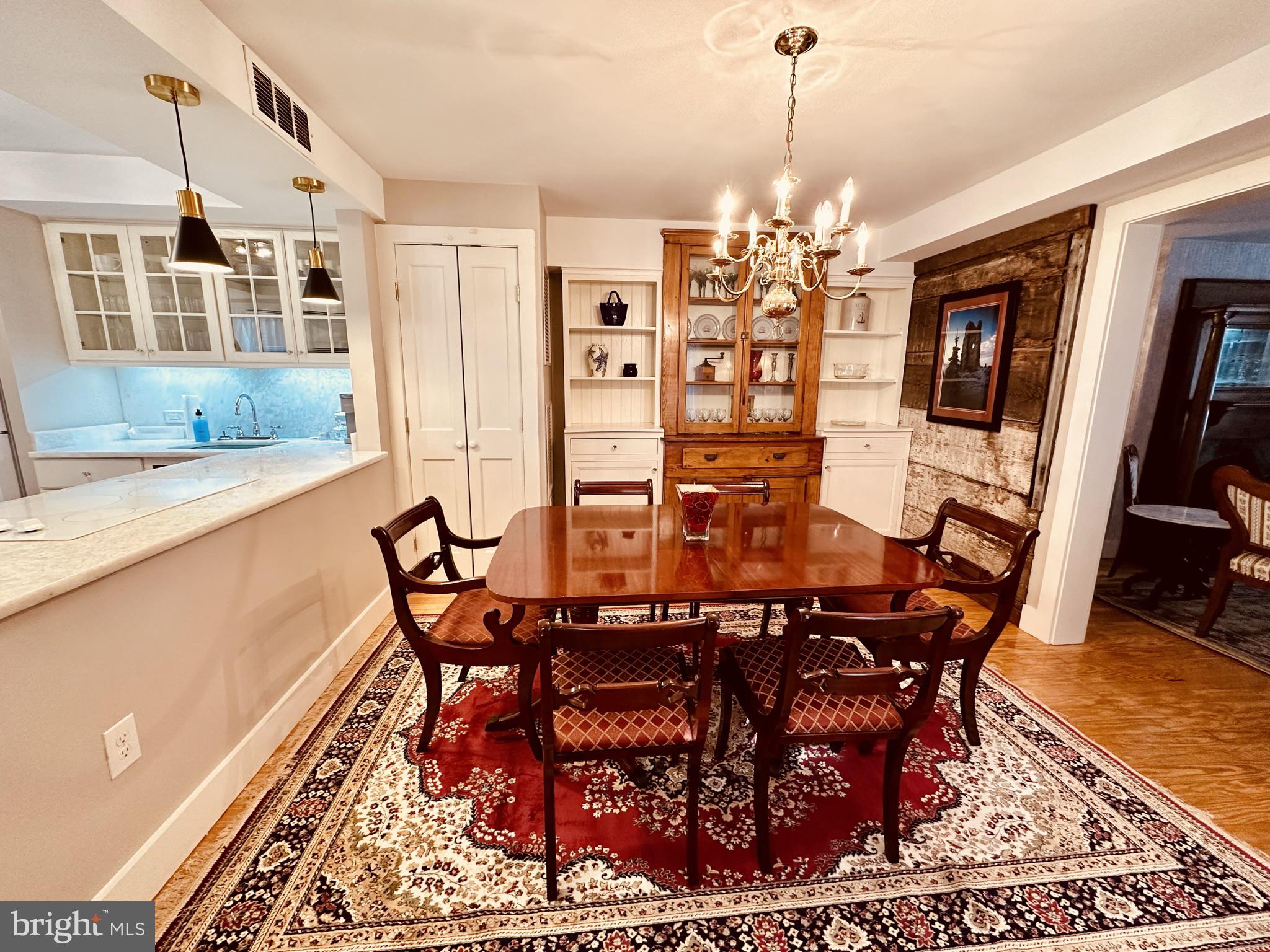 1627 Aliceanna Street Baltimore, MD 21231 - Photo 15 of 60 a view of a dining room with furniture and a chandelier