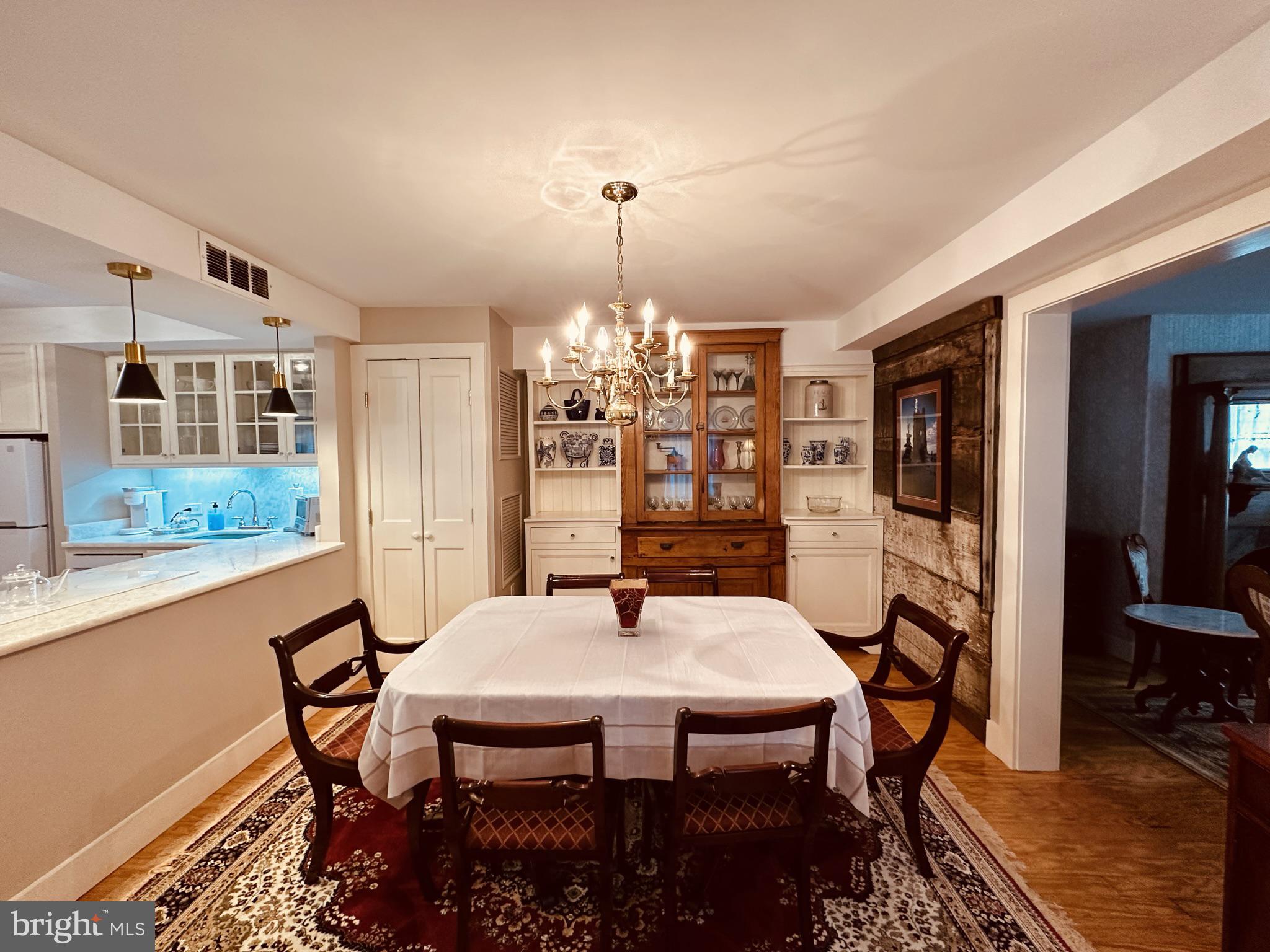 1627 Aliceanna Street Baltimore, MD 21231 - Photo 18 of 60 a dining room with furniture a chandelier and wooden floor