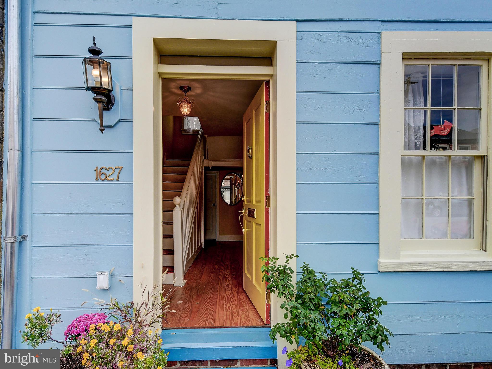 1627 Aliceanna Street Baltimore, MD 21231 - Photo 2 of 60 a view of house with wooden door and a potted plant
