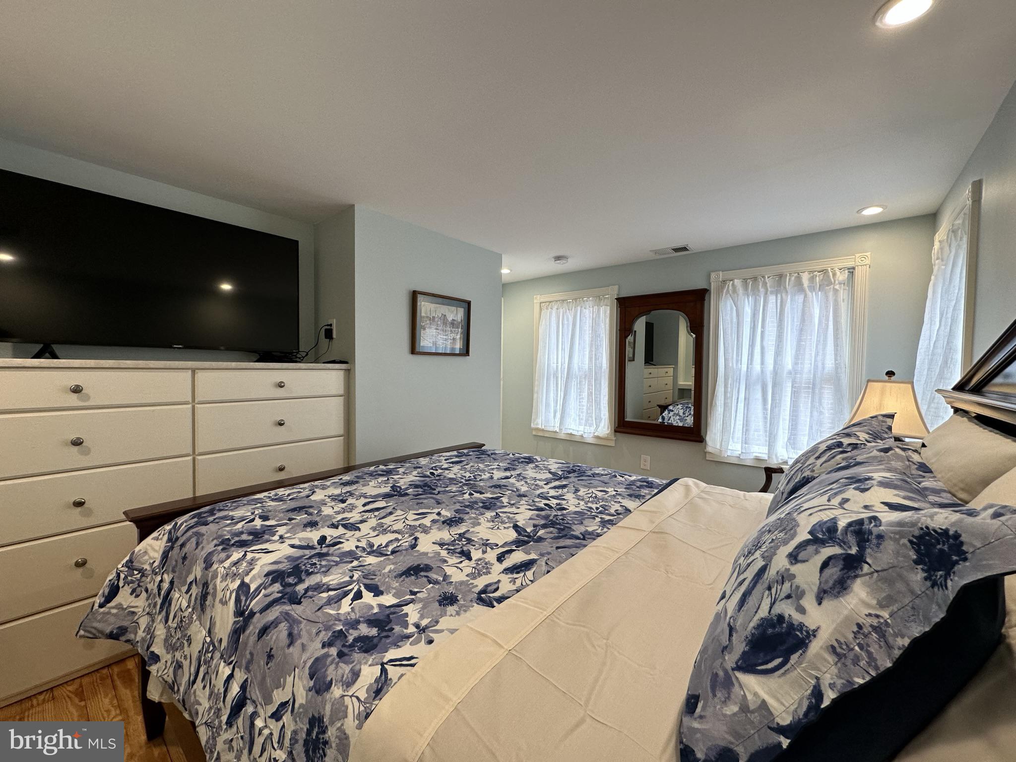 1627 Aliceanna Street Baltimore, MD 21231 - Photo 32 of 60 a bedroom with a bed and flat screen tv