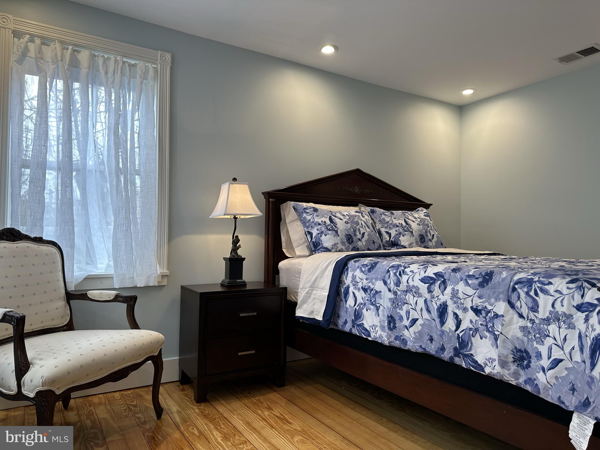 1627 Aliceanna Street Baltimore, MD 21231 - Photo 34 of 60 a bedroom with a bed and a lamp