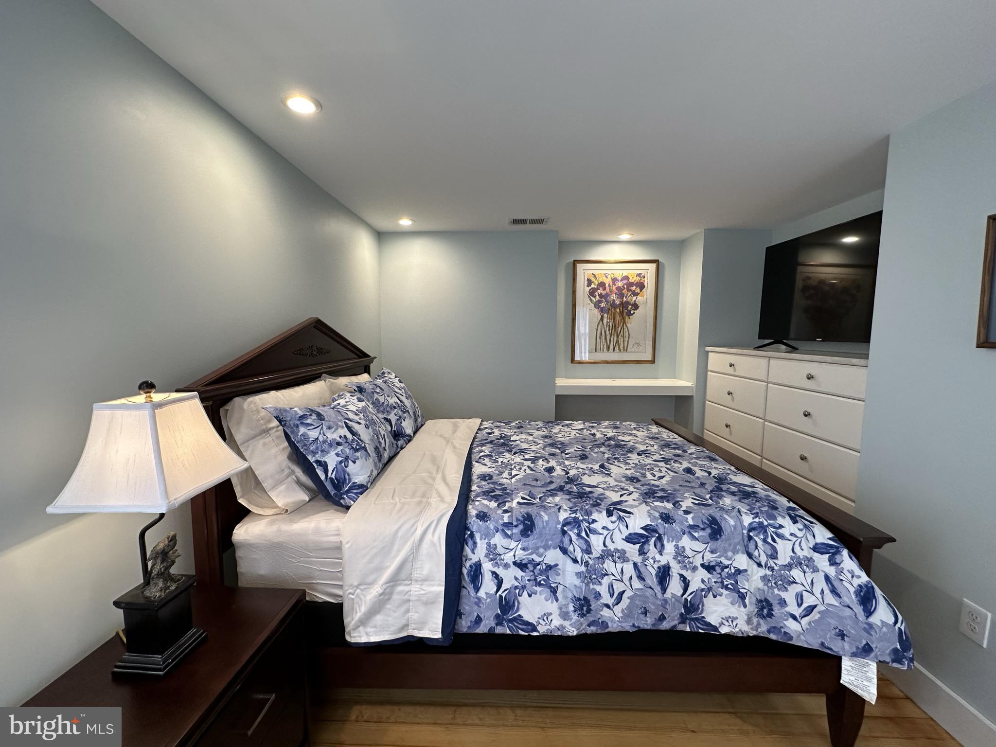 1627 Aliceanna Street Baltimore, MD 21231 - Photo 35 of 60 a bedroom with a bed and a flat screen tv