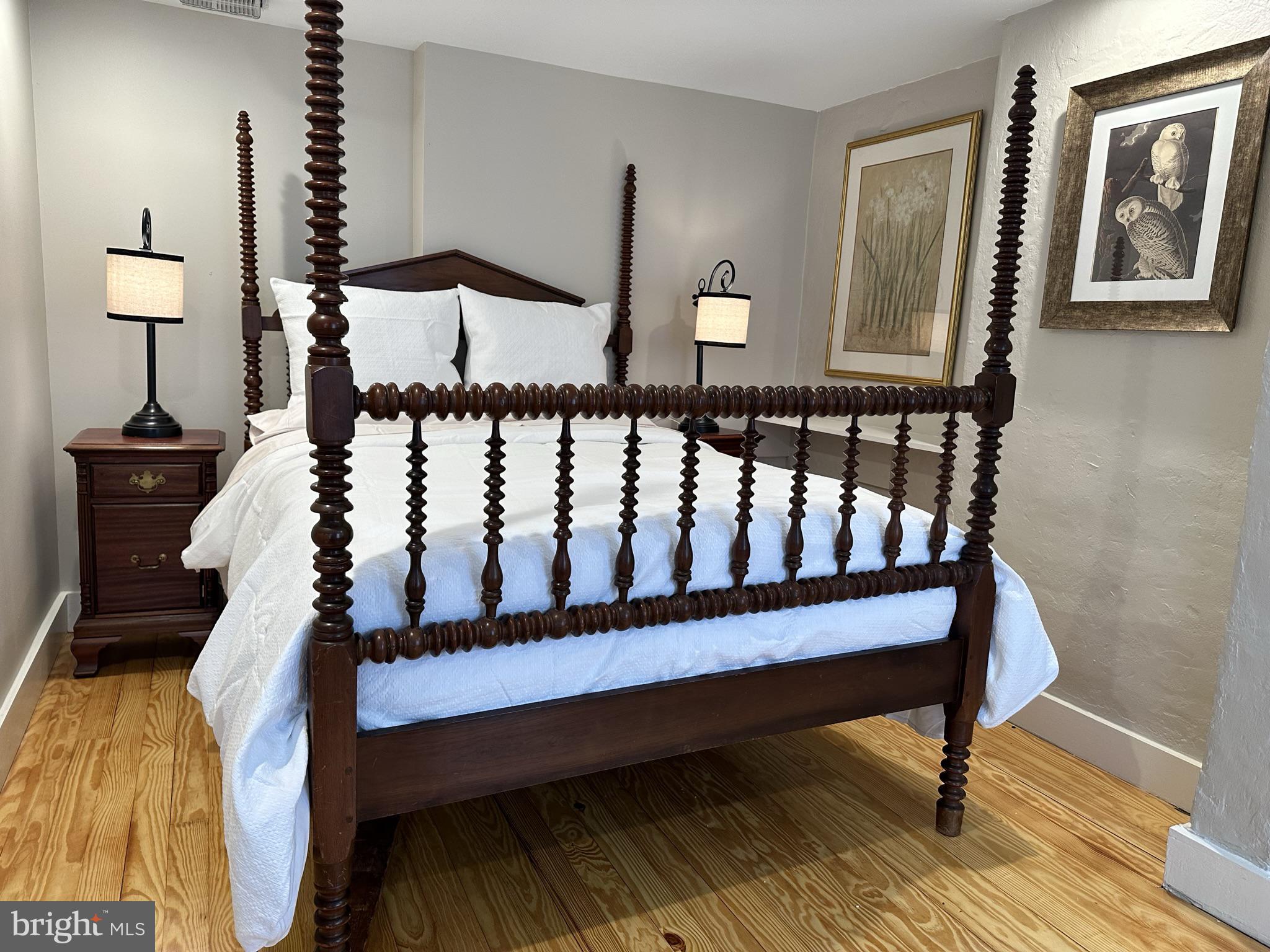 1627 Aliceanna Street Baltimore, MD 21231 - Photo 48 of 60 a bed sitting in a bedroom next to a lamp