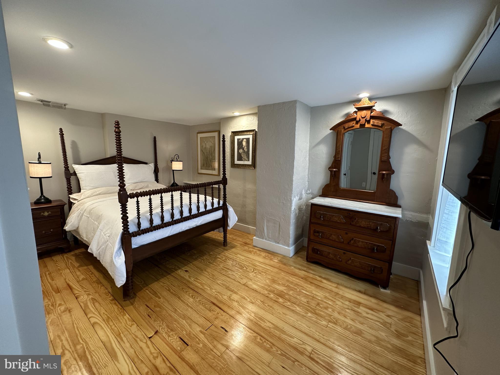 1627 Aliceanna Street Baltimore, MD 21231 - Photo 49 of 60 a bed sitting in a bedroom next to a window