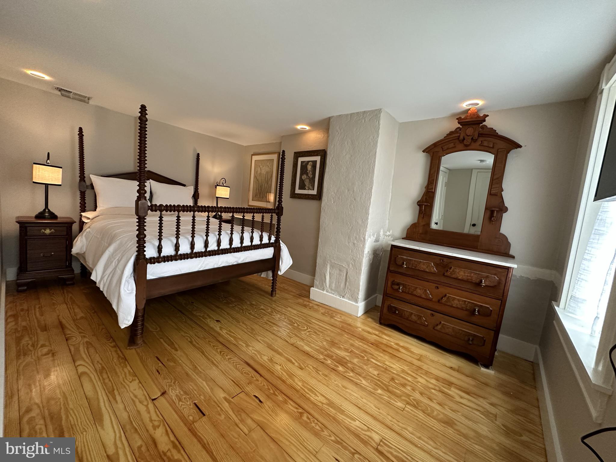 1627 Aliceanna Street Baltimore, MD 21231 - Photo 52 of 60 a bedroom with furniture and wooden floor