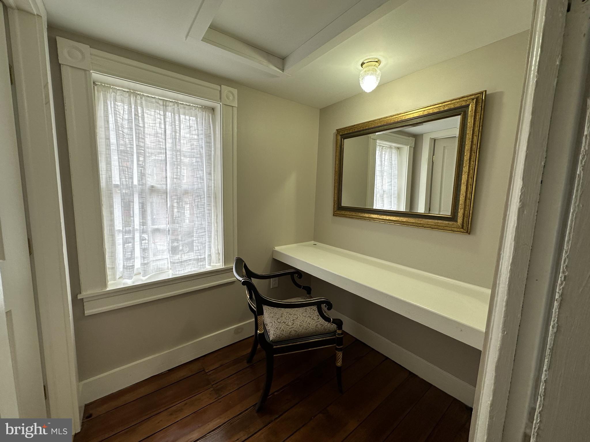 1627 Aliceanna Street Baltimore, MD 21231 - Photo 54 of 60 a room that has a chair and a window in it