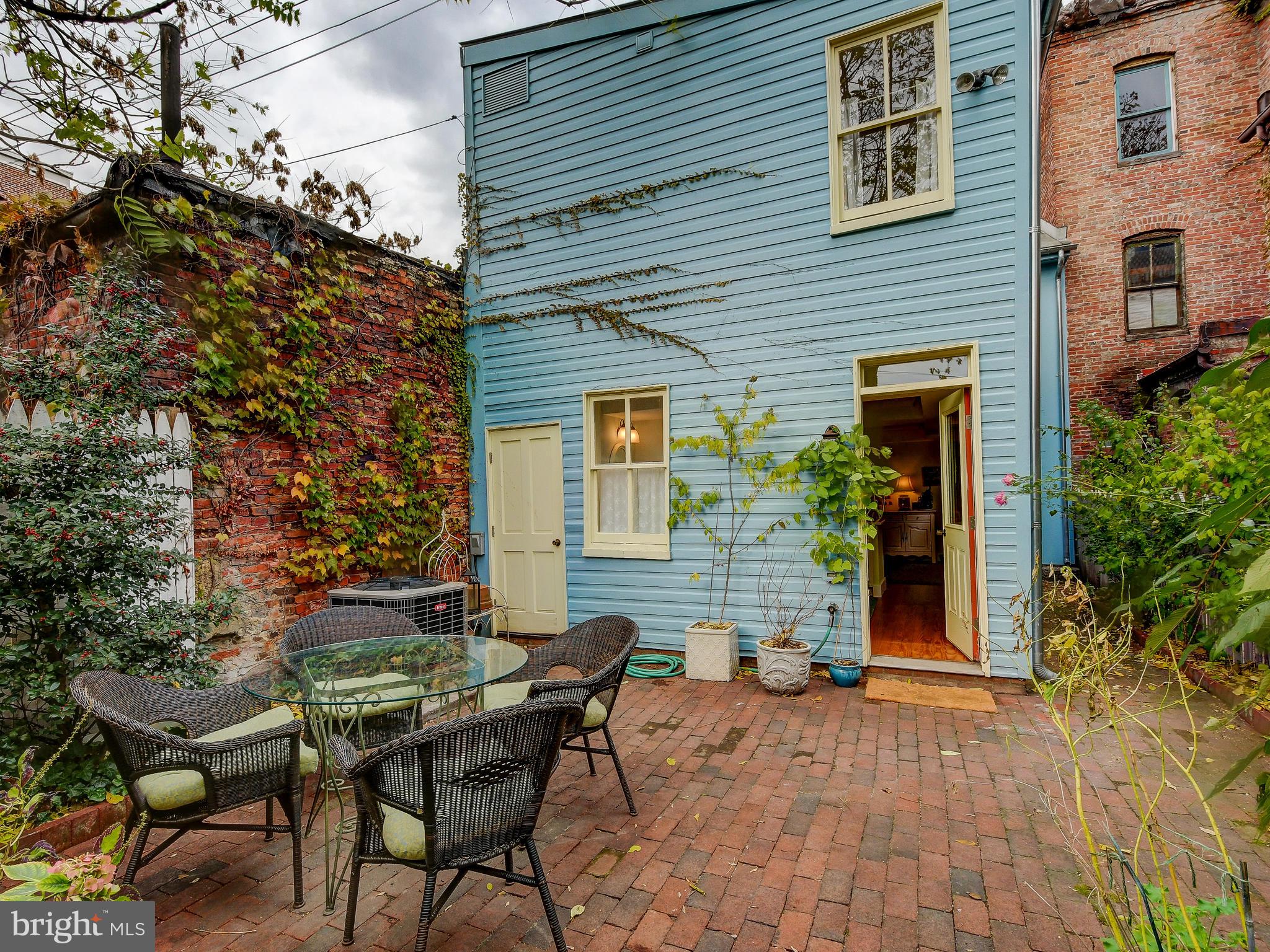 1627 Aliceanna Street Baltimore, MD 21231 - Photo 59 of 60 a backyard of a house with table and chairs