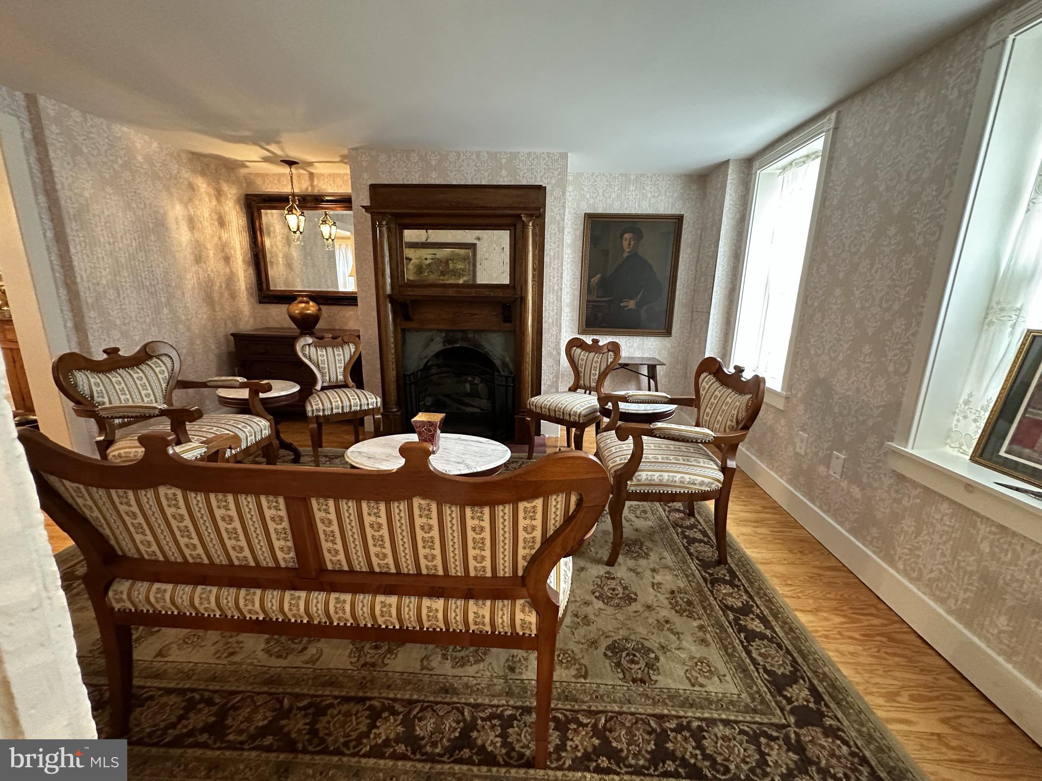 1627 Aliceanna Street Baltimore, MD 21231 - Photo 6 of 60 a living room with furniture a fireplace and a floor to ceiling window
