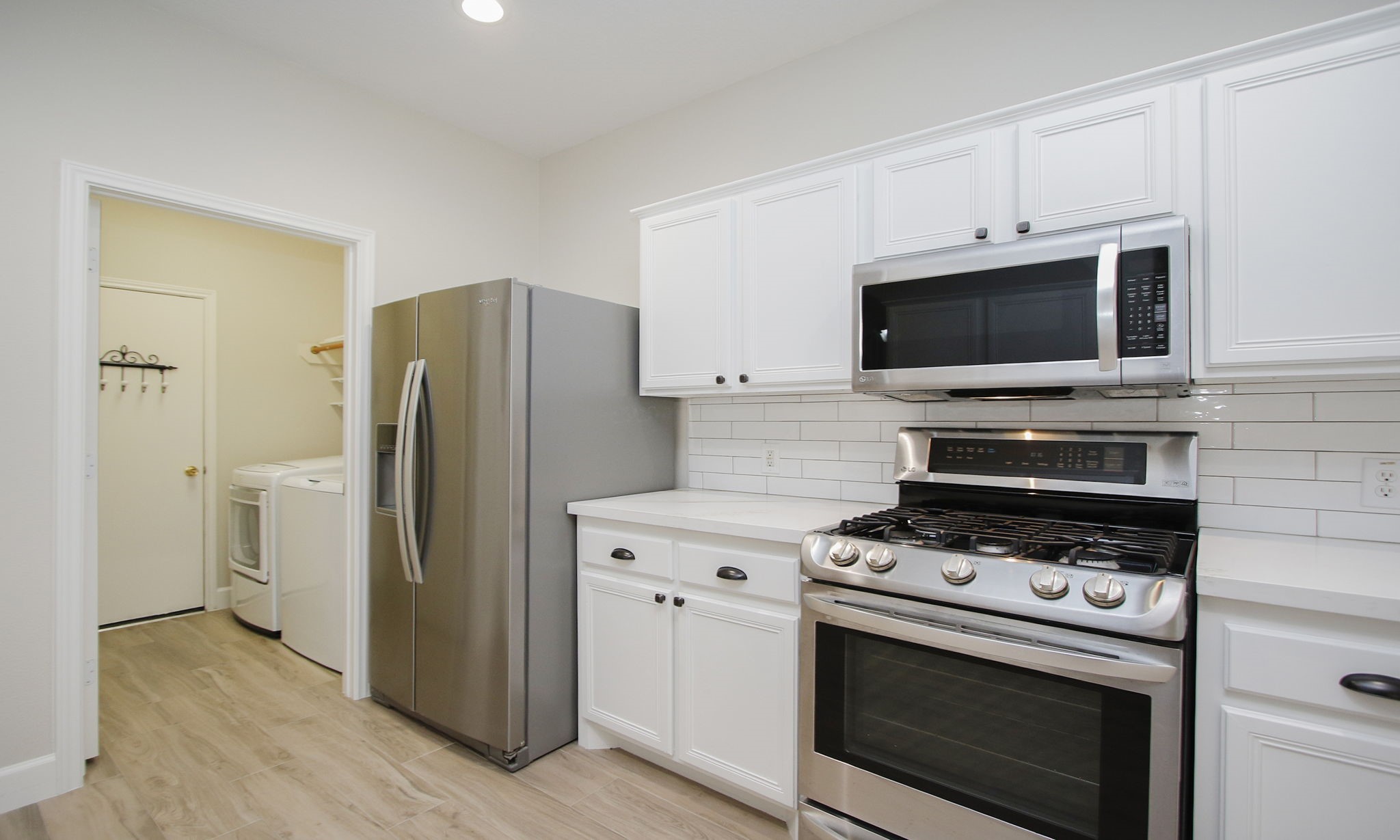 27131 Sunset Pines Drive Spring, TX 77373 - Photo 13 of 44 a kitchen with a stove microwave and refrigerator