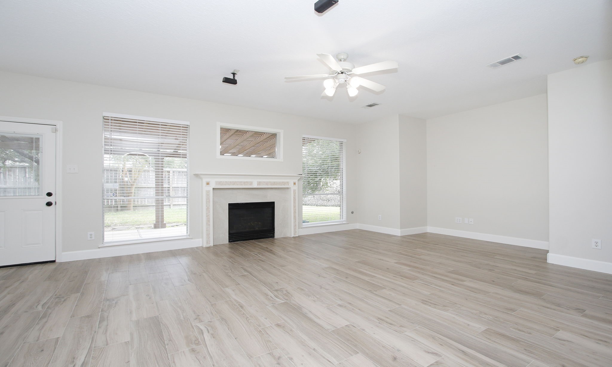 27131 Sunset Pines Drive Spring, TX 77373 - Photo 17 of 44 a view of an empty room with wooden floor and a window