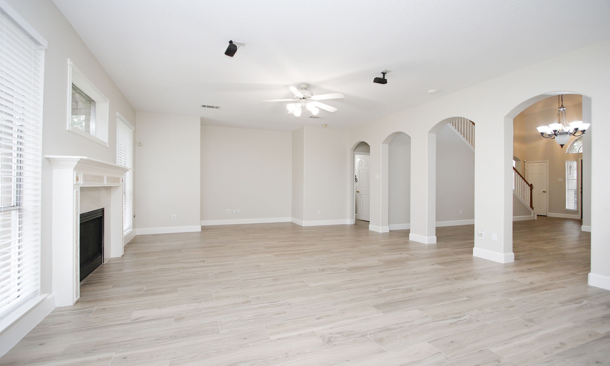 27131 Sunset Pines Drive Spring, TX 77373 - Photo 18 of 44 a view of empty room with fireplace and wooden floor
