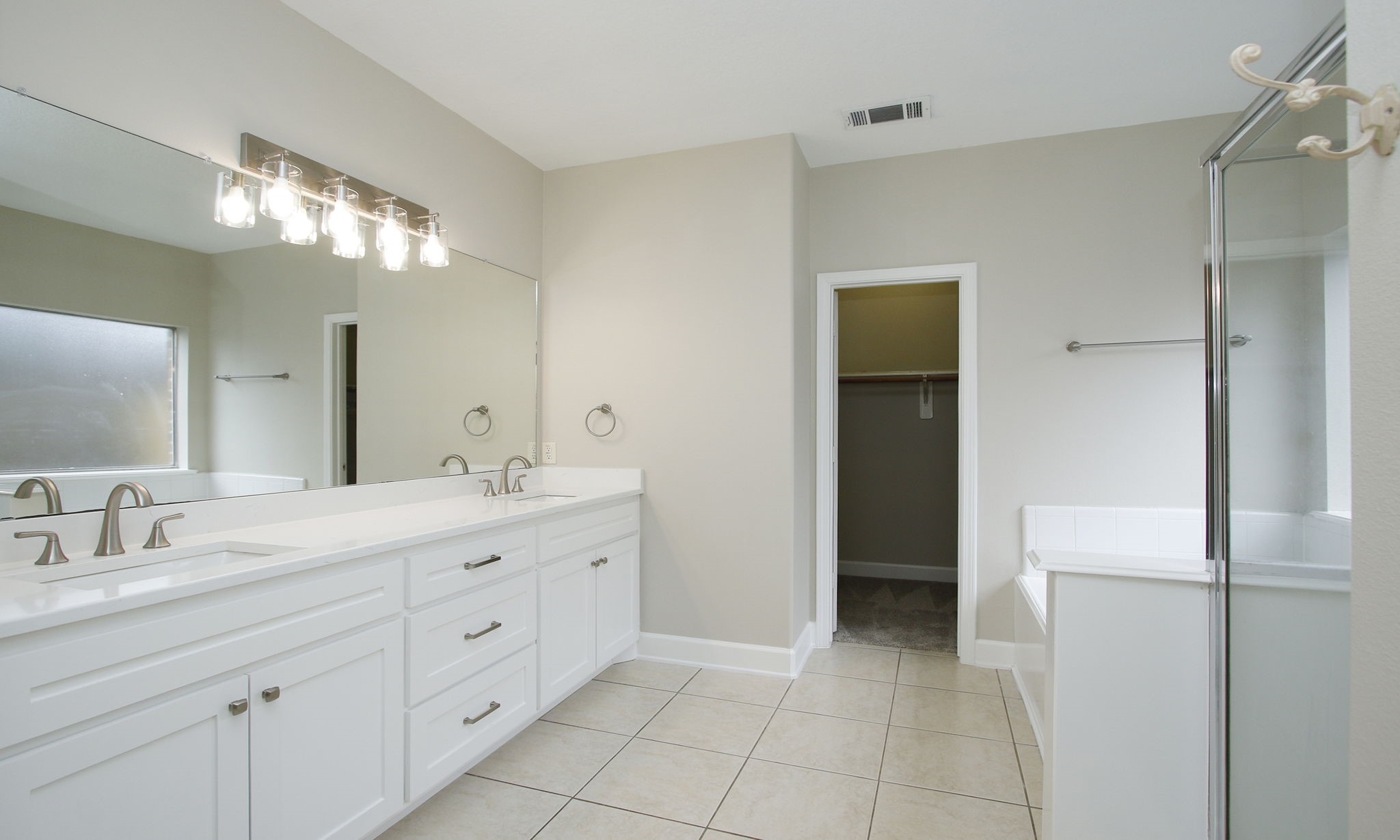 27131 Sunset Pines Drive Spring, TX 77373 - Photo 22 of 44 a spacious bathroom with a double vanity sink and a mirror