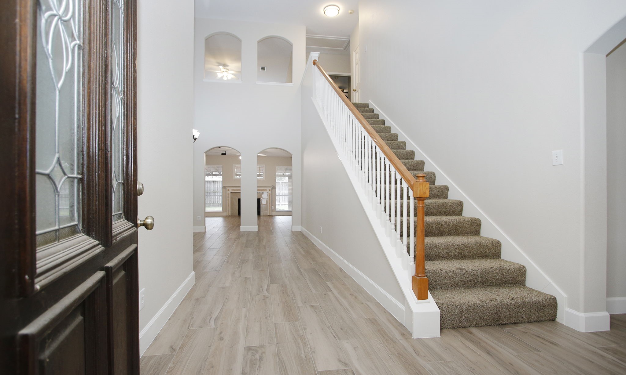 27131 Sunset Pines Drive Spring, TX 77373 - Photo 5 of 44 a view of a hallway with wooden floor and staircase