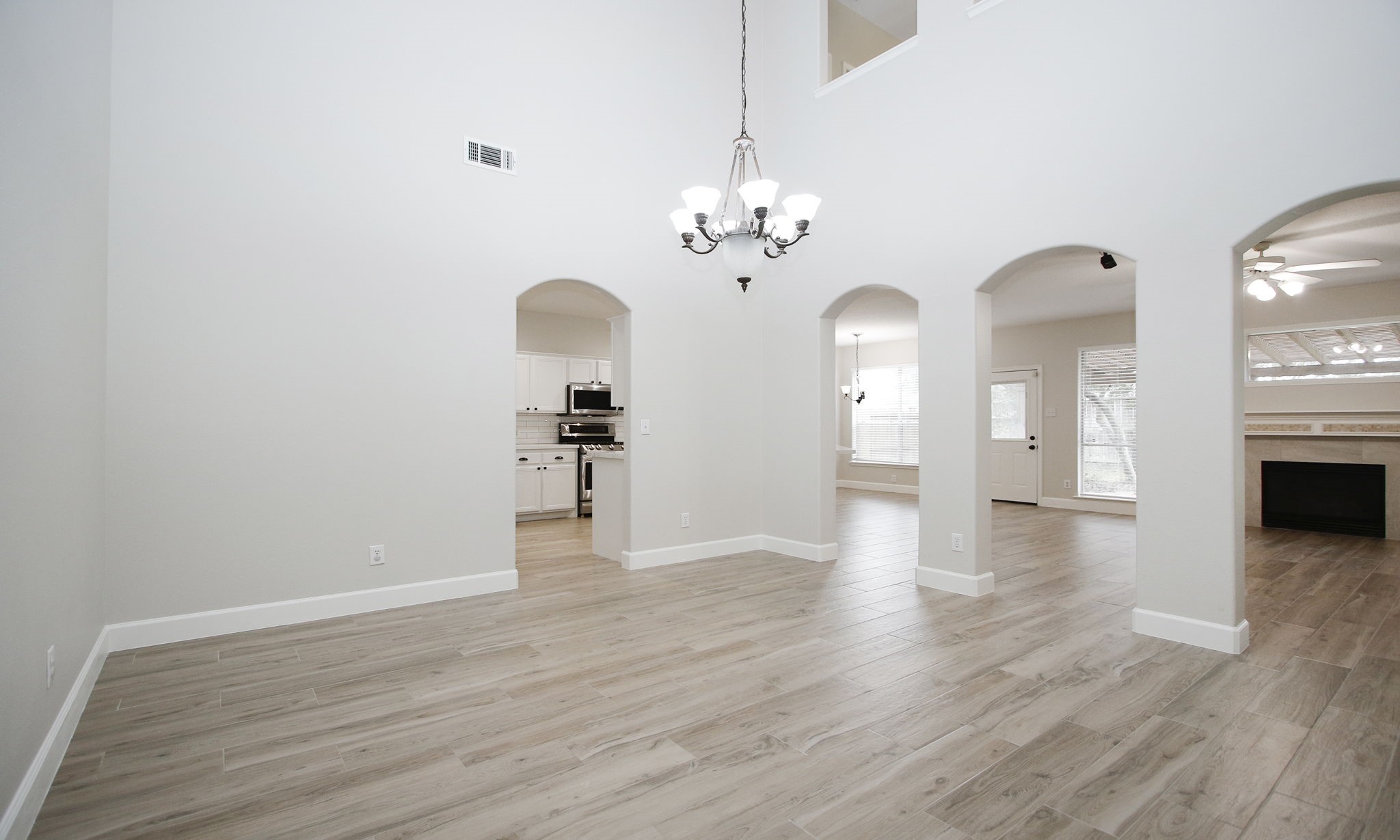 27131 Sunset Pines Drive Spring, TX 77373 - Photo 9 of 44 a view of a livingroom with a fireplace wooden floor and a chandelier