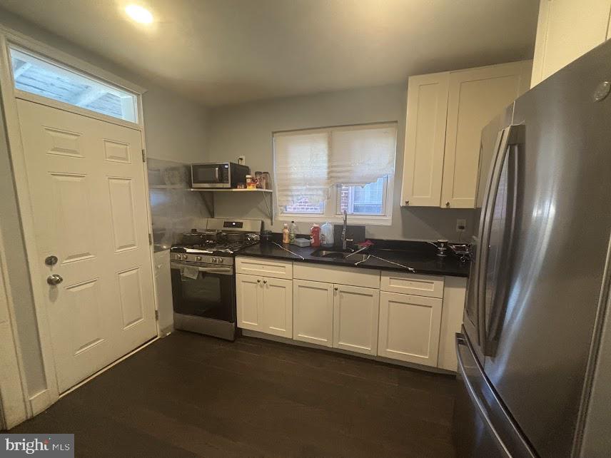 7014 Belclare Road Baltimore, MD 21222 - Photo 3 of 15 a kitchen with a refrigerator stove and sink