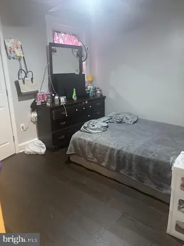 a bedroom with a bed and dresser