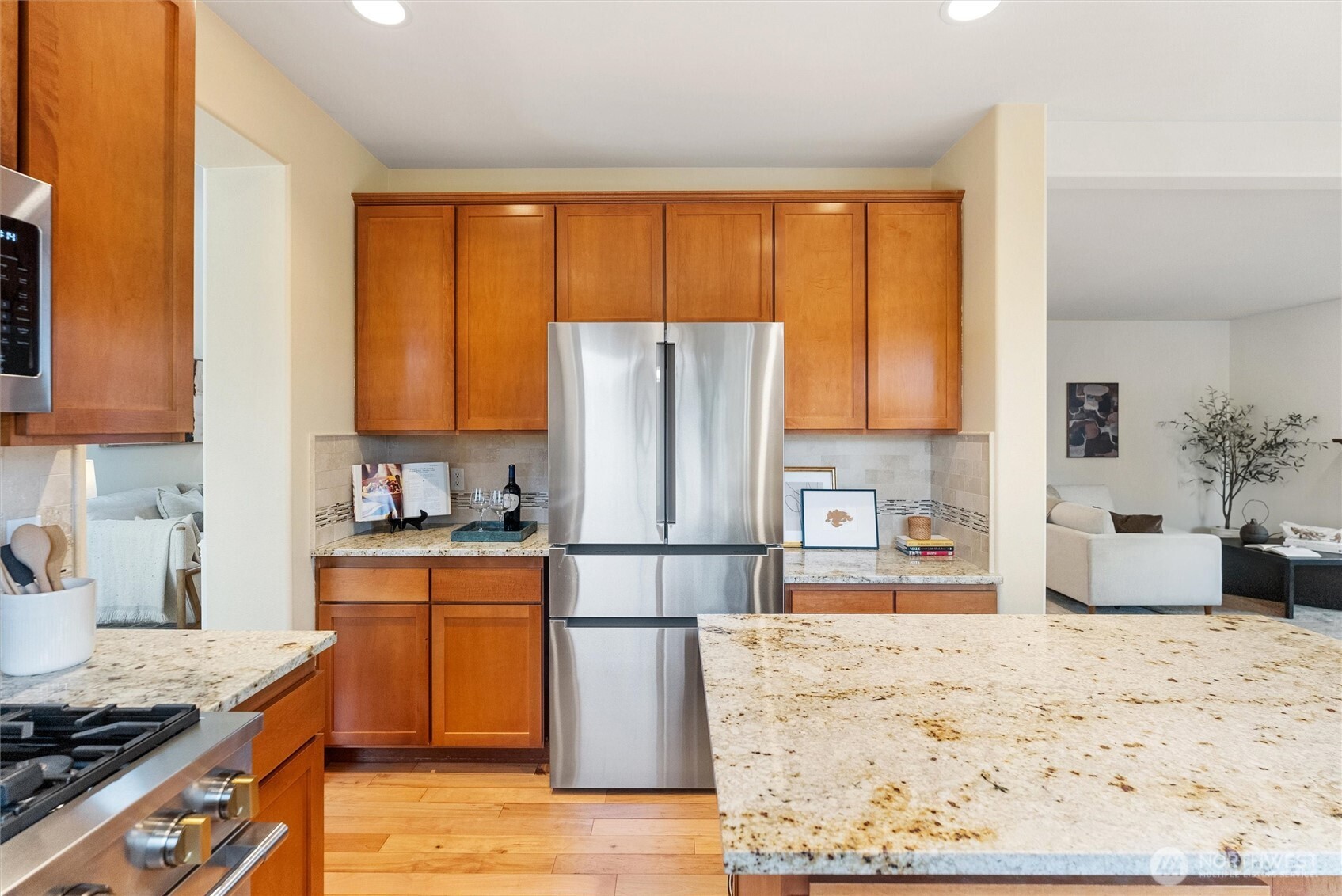 18722 3rd Avenue West Bothell, WA 98012 - Photo 12 of 35 a kitchen with stainless steel appliances granite countertop a refrigerator stove top oven and sink with wooden floor